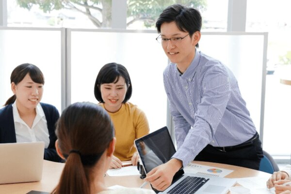 立って説明する男性社員