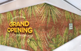 植物が重なったレンガ調の仮囲い