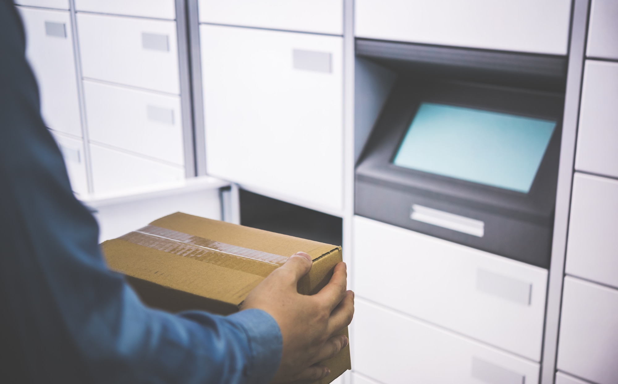 宅配ボックスに荷物を入れている