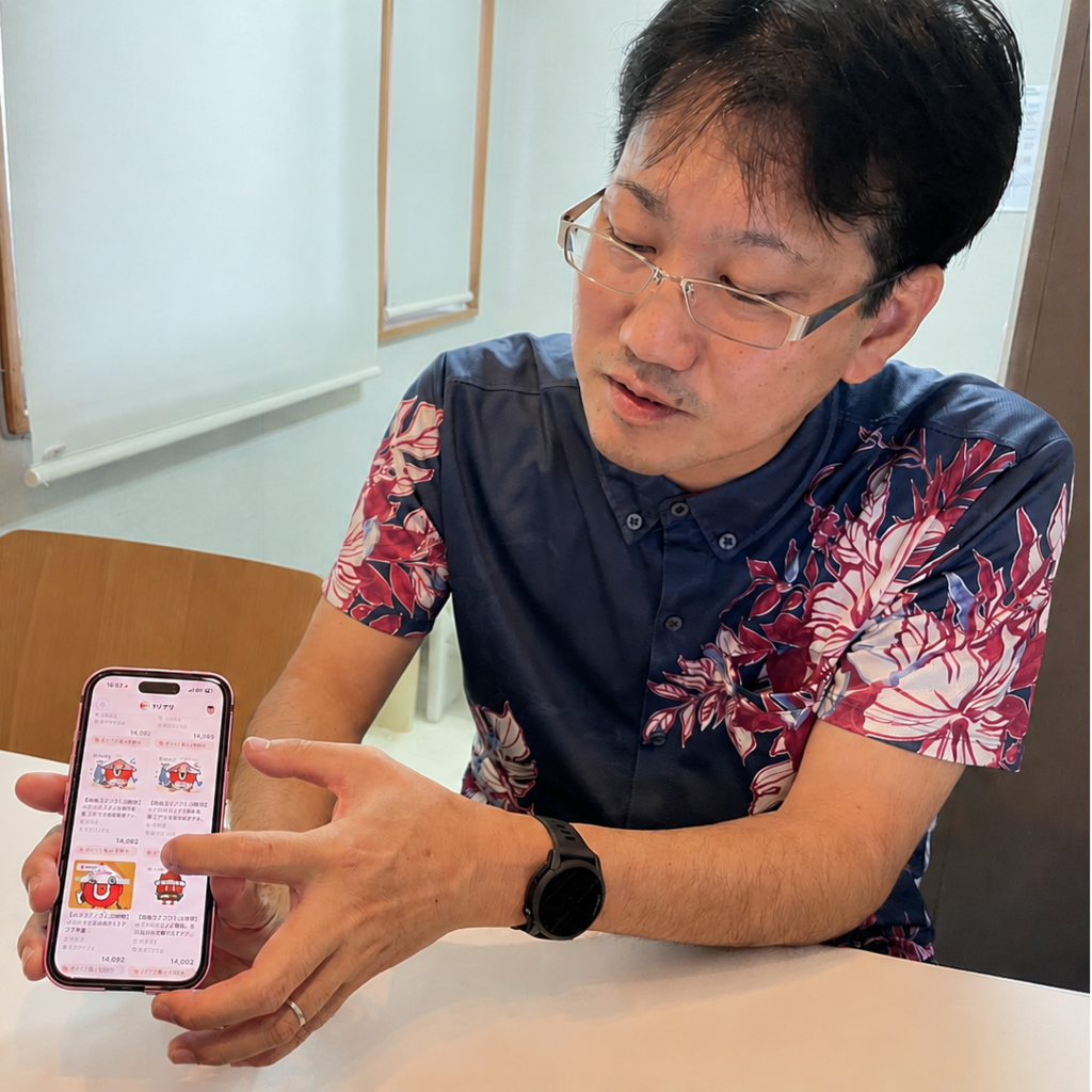 スマホを見せながら「りぴすけ」の導入効果を語るご担当者さま